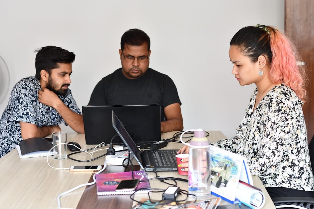 man in black crew neck t-shirt sitting beside woman in black and white floral dress