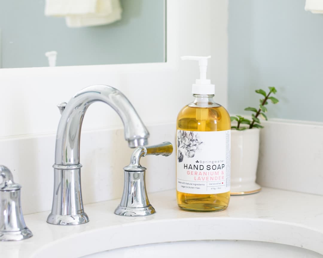 Minimal blue bathroom sink with hand soap